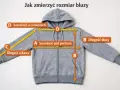 Szara bluza z kapturem, na której zaznaczono miary: szerokość pod pachami (A), długość bluzy (B), długość rękawa (C) i szerokość w ramionach (D).